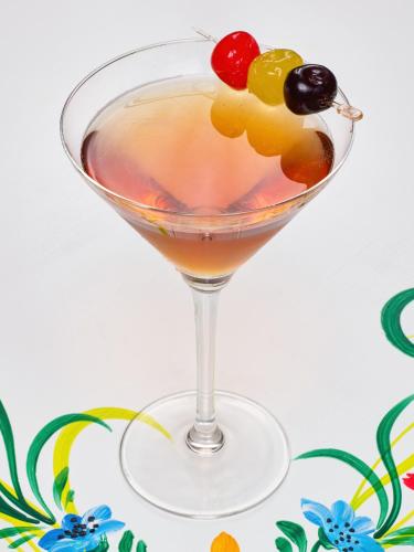 a cocktail with fruit on the rim of a martini glass at Resort EuroPark Fundata in Fundata