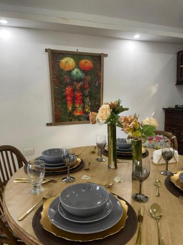 a dining room table with plates and glasses on it at Dreamvilles Ecovillage Las Galeras in Las Galeras