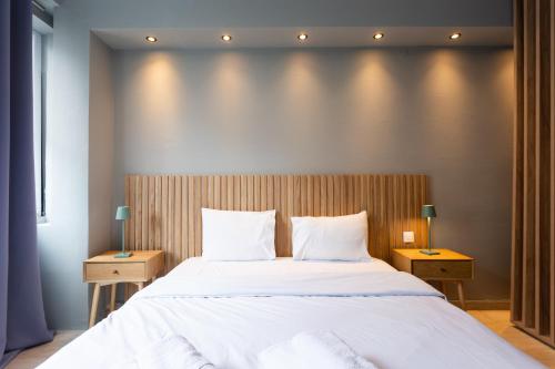 a bedroom with a large white bed with two night stands at Tsimiski double suites #8 in Thessaloniki