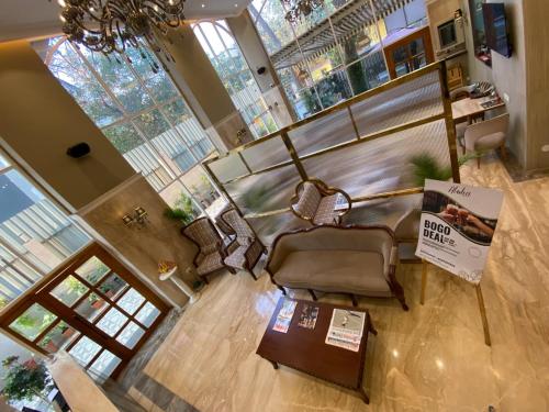 an overhead view of a living room with a table and chairs at Hotel Mumbai House Mindspace Malad in Mumbai