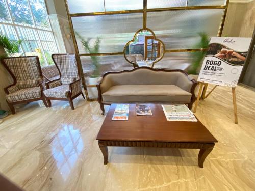 a living room with a couch and a coffee table at Hotel Mumbai House Mindspace Malad in Mumbai