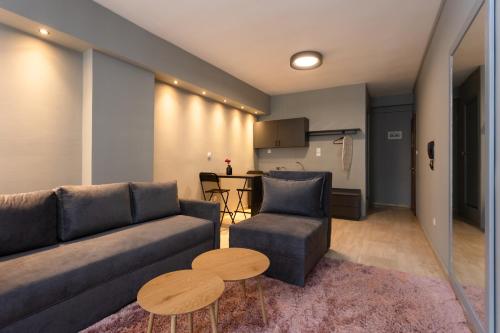 a living room with a couch and a table at Tsimiski double suites #8 in Thessaloniki