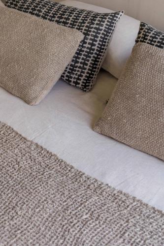 a close up of a bed with pillows on it at Velvet Bungalow in Carvalhal