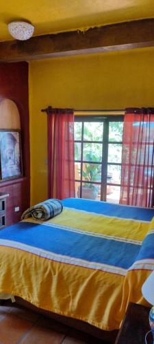 a bed in a room with a window at Villas del Amor Amor in Puerto Vallarta