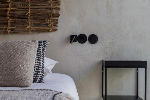 a bedroom with a bed and a side table at Velvet Bungalow in Carvalhal