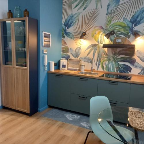 a kitchen with a counter with a sink and a table at Le Ammiraglie 2 in Savona