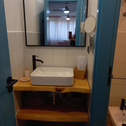 a bathroom with a white sink and a mirror at Le Ammiraglie 2 in Savona