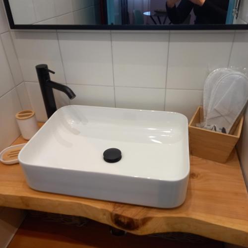 a white sink sitting on top of a wooden counter at Le Ammiraglie 2 in Savona