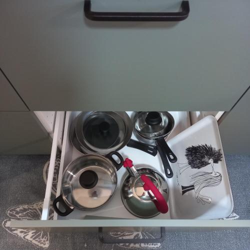 a shelf with some pots and pans in a drawer at Le Ammiraglie 2 in Savona