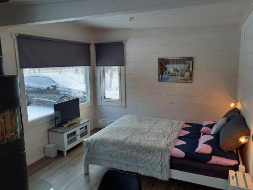 Postel nebo postele na pokoji v ubytování Im Land der Lappen Villa Pakatti