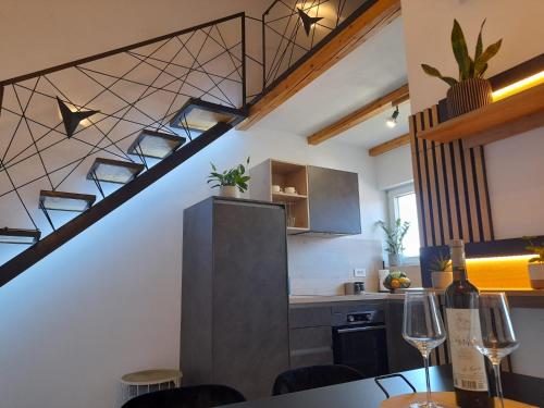 a kitchen and dining room with a spiral staircase at Island dream in Kali