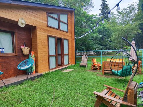 a house with a yard with a swing at Park & Beach House in Ureki Magnetiti, Sleeps 6 in Ureki