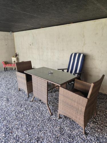 a table and chairs with a table and a chair at Little Tiny Village Haus 3 in Fußach