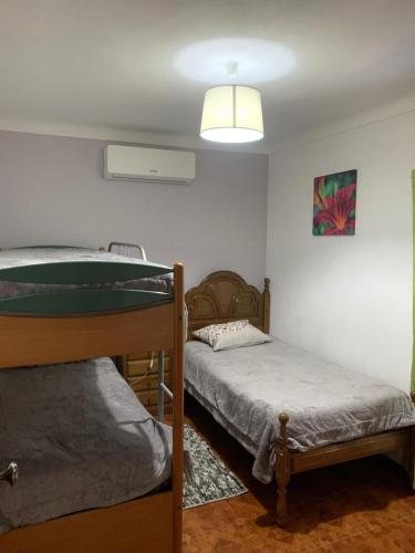 a bedroom with two bunk beds and a lamp at Quinta da Capela in Celorico de Basto