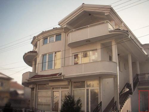 a large white house with windows on a street at Atelier22 in Prilep