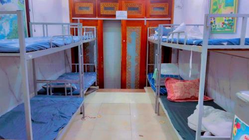 a room with three bunk beds and a door at HnHome89TL in Hanoi