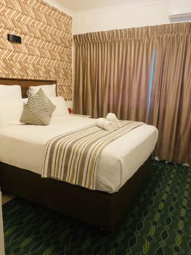 a bed in a hotel room with at Dwengu Guest house in Margate