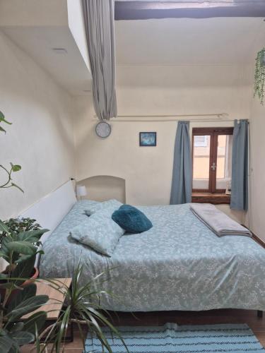 a bedroom with a bed with blue pillows at Sogno di Pinka in Calcata