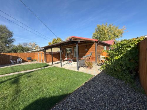 a wooden house with a fence and a yard at Cabin 2BR 2BA home, 3 min to airport and downtown in Boise