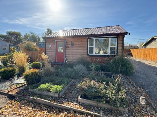 a small house with plants in a yard at Cabin 2BR 2BA home, 3 min to airport and downtown in Boise