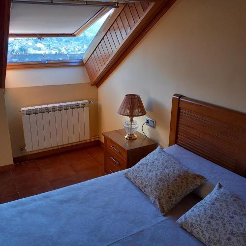a bedroom with a large bed and a window at Casa Bravo in Gondomar