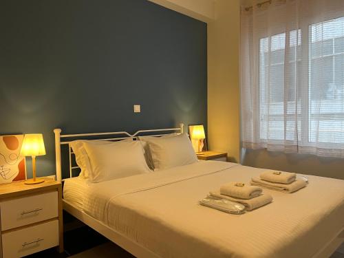 a bedroom with a large bed with towels on it at Mosaikon Guesthouses #Kolokotroni Str in Athens