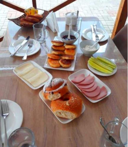 a wooden table with plates of pastries on it at Sunny days Kobuleti in K'obulet'i