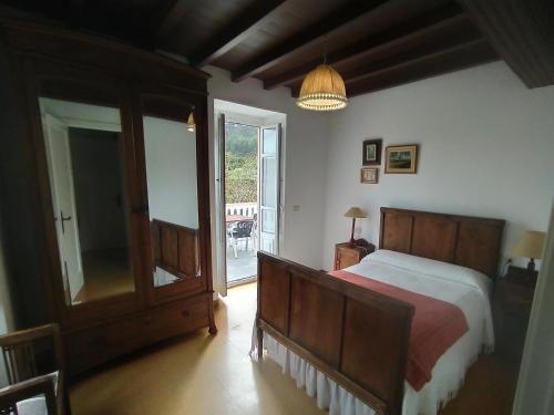 a bedroom with a bed and a sliding glass door at Casa Rubal in Foz