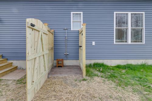 a wooden gate in front of a blue house at Walk to Bay Home with Fenced Yard in Colonial Beach in Colonial Beach