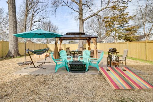 a patio with a table and chairs and an umbrella at Walk to Bay Home with Fenced Yard in Colonial Beach in Colonial Beach