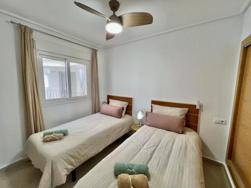 a bedroom with two beds and a window at Beautiful apartment with golf and mountains view in Sucina