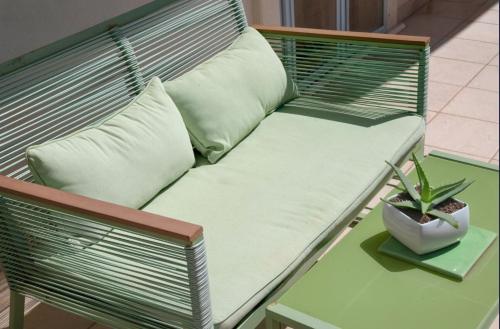 a bench with a pillow and a plant on a table at Le Terrazze in Otranto