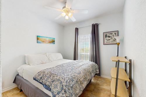 a bedroom with a bed and a ceiling fan at Myrtle in Rockport