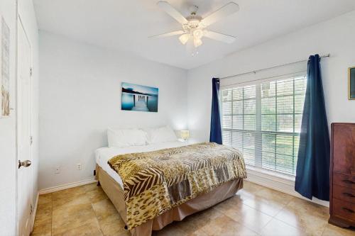 a bedroom with a bed and a ceiling fan at Myrtle in Rockport