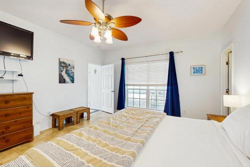 a bedroom with a bed and a ceiling fan at Myrtle in Rockport