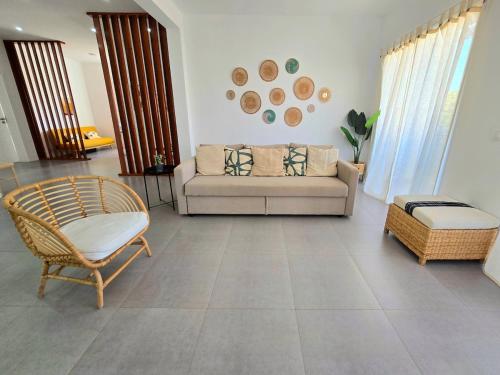 a living room with a couch and a chair at Casa Bela in Mindelo