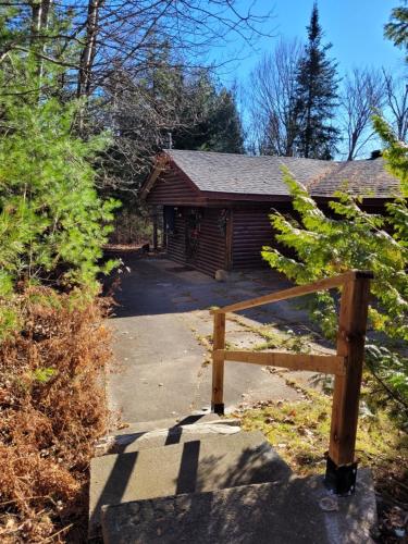 a house with a wooden gate in front of it at Chalet "Ici et maintenant, sur le lac" in Sainte-Marguerite