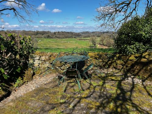 a table and chair sitting on top of a field at Gîtes du Gohic in Quistinic