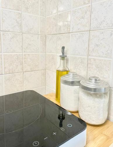 a counter top with two jars and a bottle of oil at La casa di vale in Molfetta