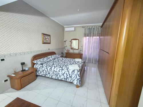 a bedroom with a bed and a table and a mirror at B&B Borgo San Martino in Zagarolo
