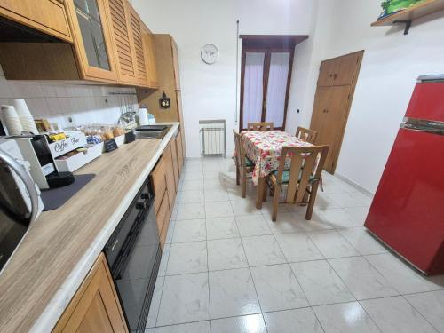 a kitchen with a table and a red refrigerator at B&B Borgo San Martino in Zagarolo