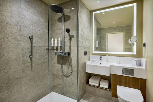 a bathroom with a shower and a sink at Courtyard by Marriott Lyon Eurexpo Stadium in Genas