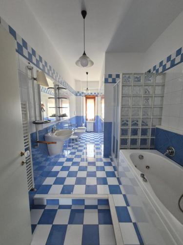 a blue and white bathroom with two sinks and a tub at B&B Borgo San Martino in Zagarolo