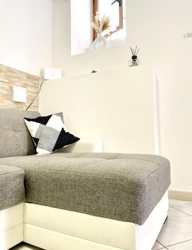 a bedroom with a bed and a white wall at La casa di vale in Molfetta
