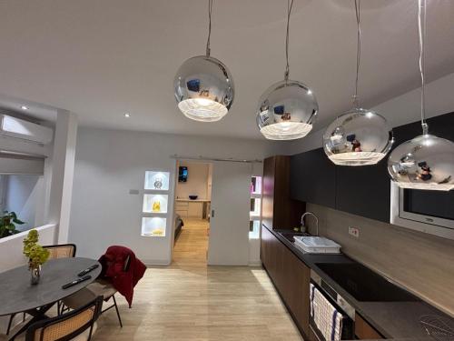 a kitchen with several lights hanging from the ceiling at Sliema Maisonette in city center in Sliema