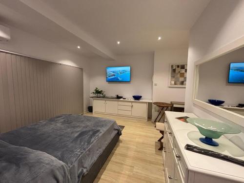 a bedroom with a bed and a sink in it at Sliema Maisonette in city center in Sliema