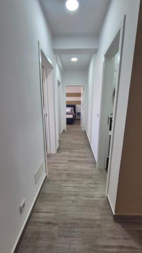 a hallway with white walls and a long hallway with doors at Appartamenti Praia Estoril, Sal Rei, Boa Vista in Sal Rei