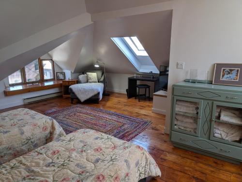 a attic room with a bed and a green stove at Cozy 2-Bedroom Downtown Apartment in London