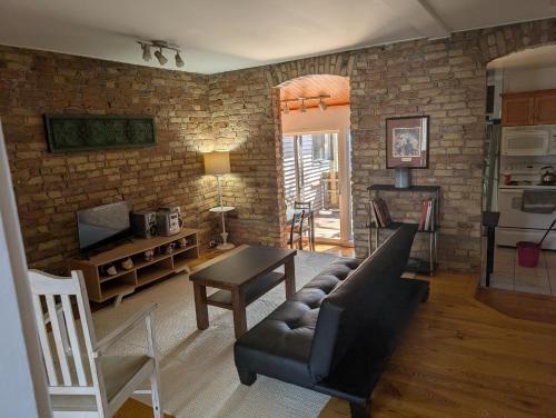 a living room with a couch and a table at Cozy 2-Bedroom Downtown Apartment in London