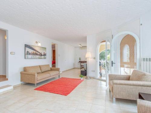 - un salon avec deux canapés et un tapis rouge dans l'établissement Vubel Modern Villa, à Saint-Tropez